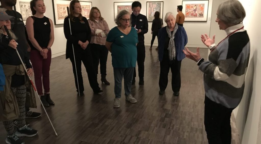 Group of white cane users in art gallery